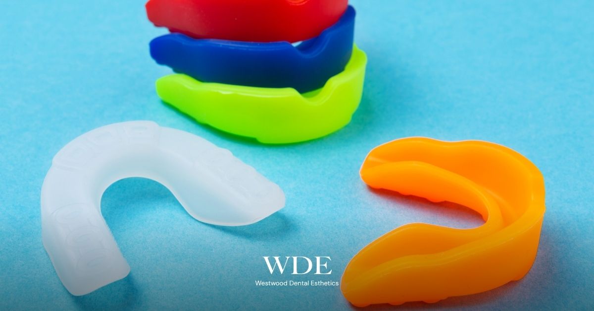 Night Guards vs. Mouth Guards: Which One Do You Actually Need? 1 Custom sports mouth guards in multiple colors displayed to illustrate dental protection for athletes and impact sports.